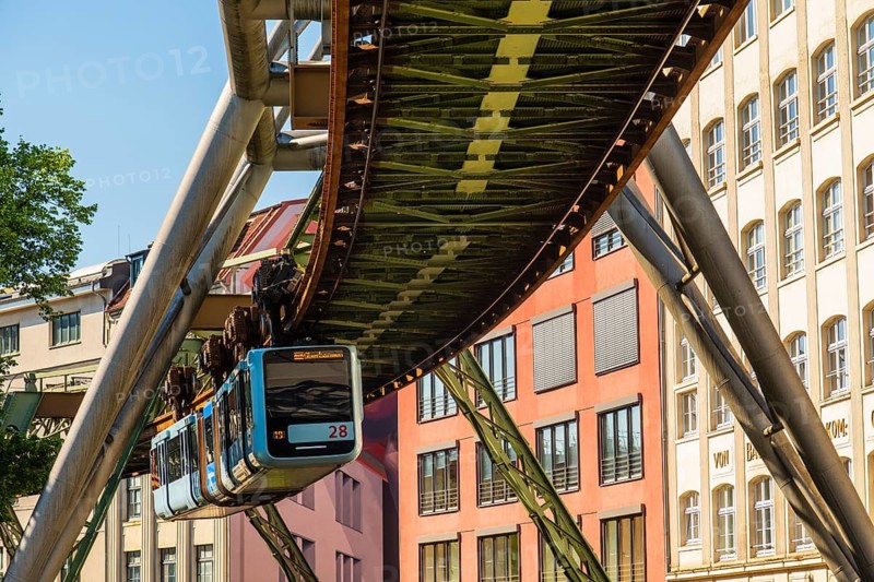 A suspension railway runs between old industrial buildings near the Kluse stop, Wuppertal, Germany