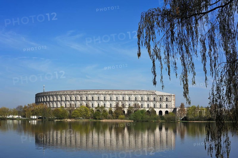 General view of the former incomplete Congress Hall of the NSDAP 1933-1945, in front the bun pond and trees, documentation center, Reichsparteitagsgelände, Bayernstraße 110, Nuremberg, Middle Franconia, Bavaria, Germany