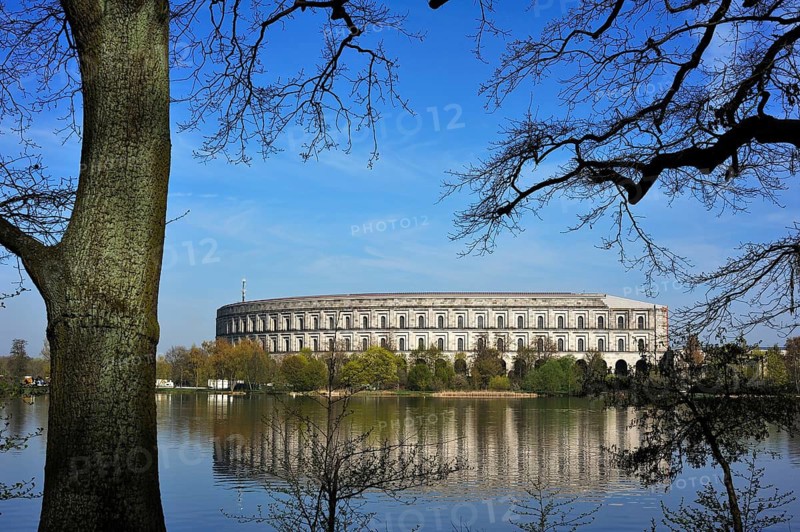 General view of the former, unfinished NSDAP Congress Hall, 1933–1945, with the Dutzenteich and lime trees (Tilia platyphyllos) in the foreground, Documentation Centre, Reich Party Rally Grounds, Bayernstraße 110, Nuremberg, Middle Franconia, Bavaria, Germany