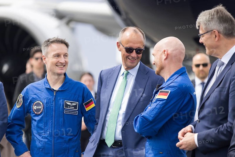 Friedrich Merz (Chancellor of the Federal Republic of Germany, CDU, wearing sunglasses) chats with the two German astronauts Alexander Gerst and Matthias Maurer at the ILA (International Aerospace Exhibition) on 10 June 2026 at the Berlin-Schönefeld Exhibition Centre