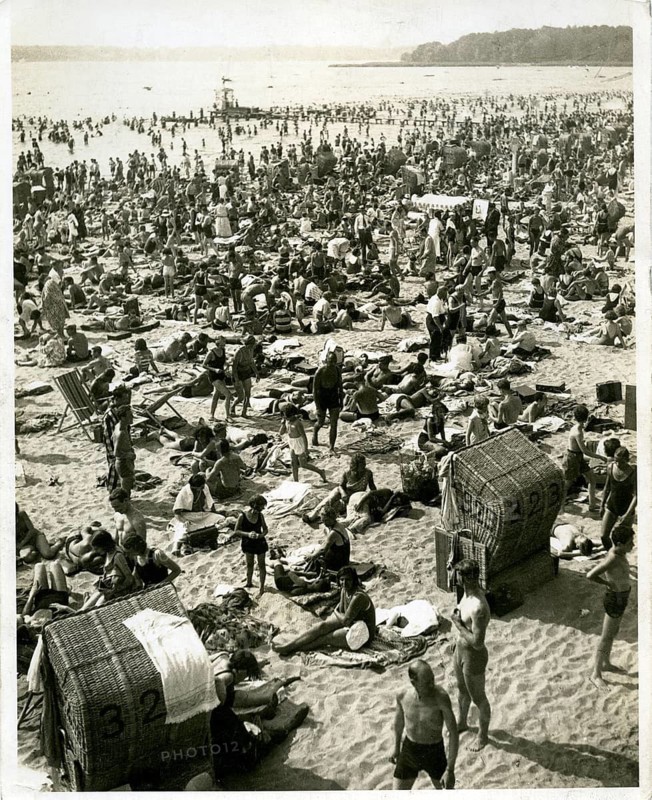 Berlin, Stransbad Wannsee, summer, fun, swimming, swimwear, families, overcrowding. Lively beach with lots of people and traditional beach chairs by the sea, John, 1932