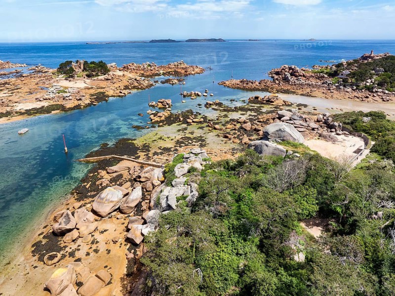 Aerial view of the picturesque coastal landscape on the Pink Granite Coast with the neo-Gothic Château de Costaérès on an island at low tide, Ploumanac'h, Perros-Guirec, Trégastel, Côtes-d'Armor department, Brittany region, France