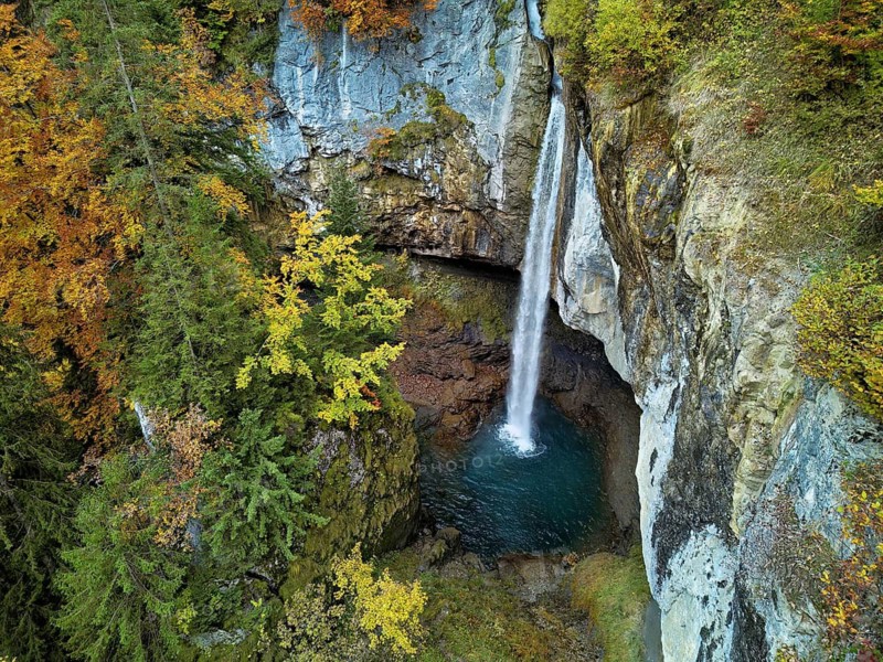 Aerial view of Berglistüber waterfall in autumn-colored surroundings, Linthal, Klausenpass, Canton of Glarus, Switzerland