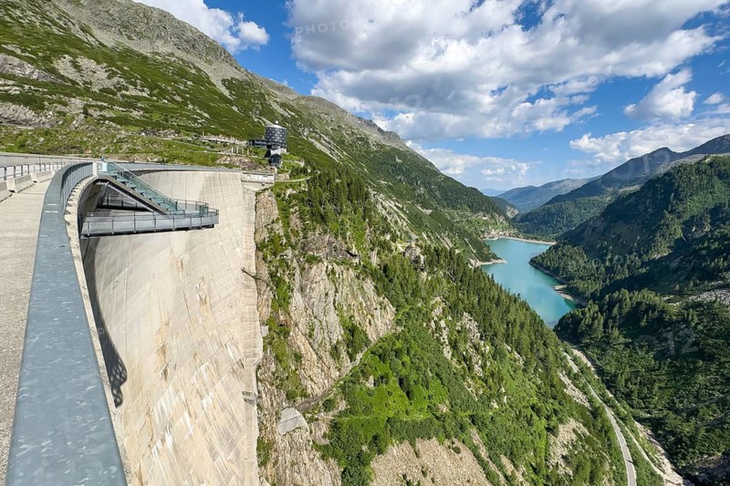 View of Kölnbrein Reservoir on air side of dam wall facing away from the water with floating viewing platform Airwalk on the left, behind it modern mountain hotel Malta in the background, Galgenbichl Reservoir on the right, Malta Valley, Carinthia, Austria