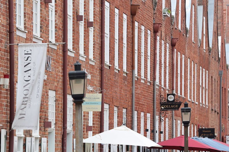Row of red brick houses with umbrellas, Dutch Quarter, Potsdam, Havelland, Brandenburg, Germany