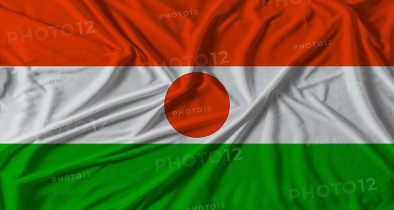 Niger flag with fabric texture background. National flag of Niger with cloth texture