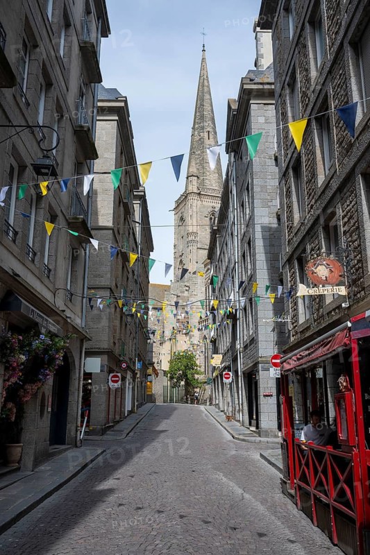 View through the historic Grand'Rue in the old town, Intra-Muros, from Saint Malo with the distinctive tower of Saint-Vincent Cathedral, Ille-et-Vilaine department, Brittany, France