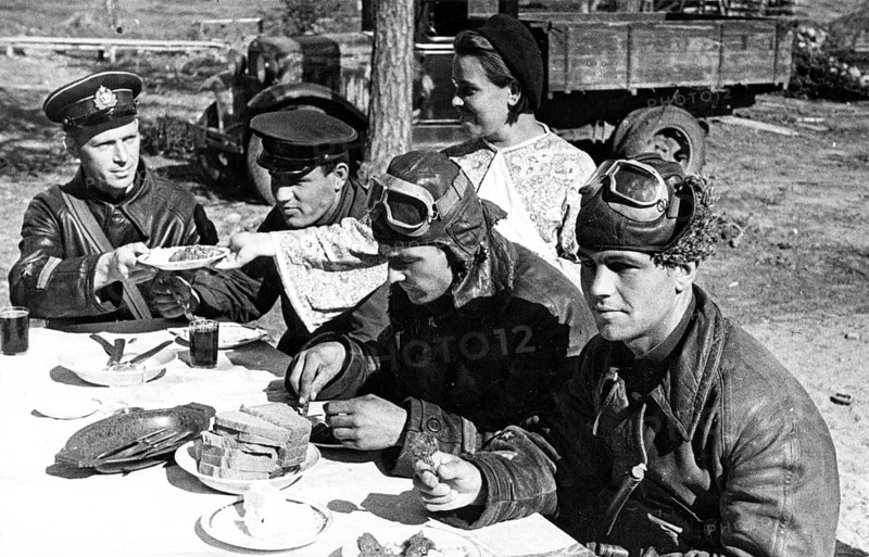 Soviet and British soldiers (pilots) having a meal on the Northern Front, Murmansk, Soviet Union, 1942