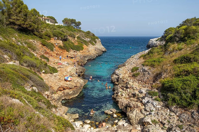 People bathe in Cala Muta Bay in Majorca, Cala Muta, Porto Cristo, Majorca, Spain
