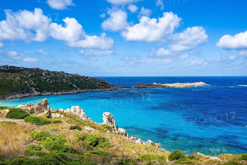 Coastline with emerald green and blue water on a sunny day at Santa Teresa di Gallura, Sardinia, Italy