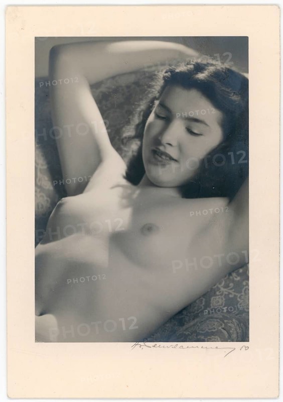 Nude, young woman in the sun, woman lying relaxed with smiling facial expression, appears calm and relaxed, around 1940