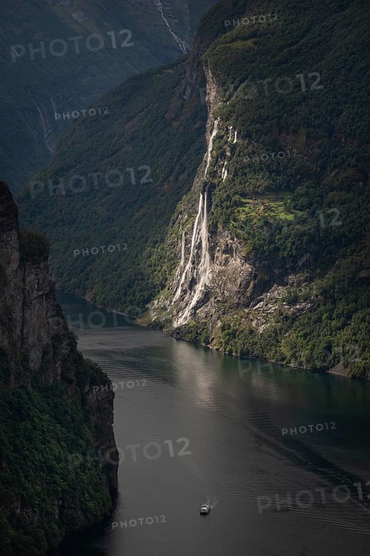 Group of waterfalls, seven sisters, dei sju systrene, Knivsflåelvane, Knivsflåfossen, remote Knivsflå mountain farm, dramatic lighting, ship, north side UNESCO World Heritage Site Geirangerfjord, Stranda Municipality, Møre og Romsdal, Norway