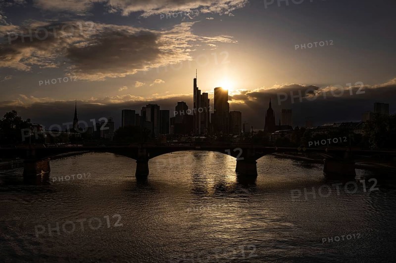 The sun sets behind Frankfurt's banking skyline, Frankfurt am Main, Hesse, Germany
