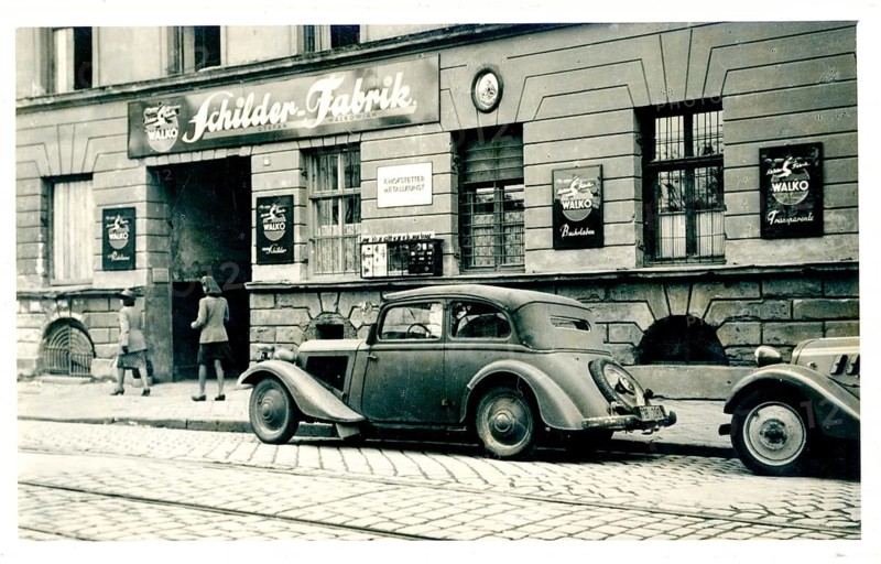 Vienna, shop, sign factory, Stafan Walkowiak, vintage car, Adler Coupe, An old car parked in front of a building with advertising signs above a workshop door, around 1928
