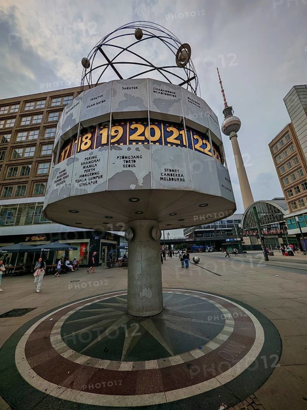 The world clock on Alexanderplatz with the Berlin television tower in the distance on an overcast day, Alexanderplatz, Berlin