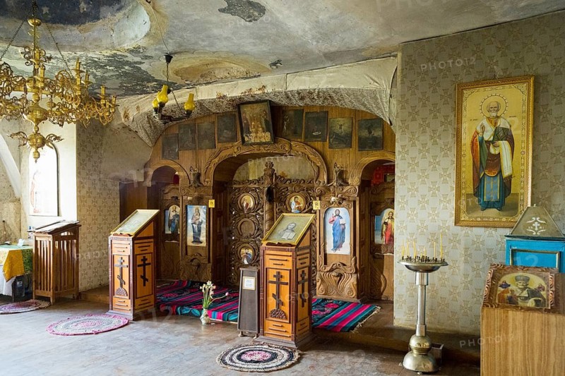 Richly decorated Orthodox interior with icons and candles under a chandelier, cave church, rock caves, cave dwellings, ?ipova monastery, Uspenski monastery, Tipova, Rezina region, Republic of Moldova, Moldova