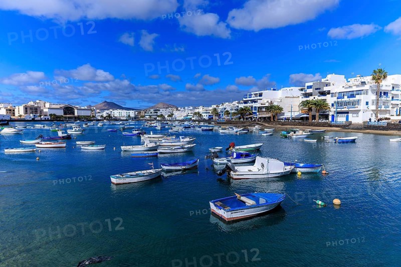 Lanzarote, Canary Islands, Spain, Europe, Charco San Gines harbour in Arrecife, A quiet harbour full of boats against a backdrop of white houses under a clear blue sky
