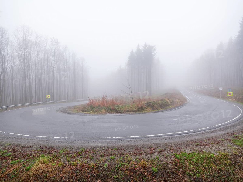 Sweeping a mountain pass in fog, Maramures, Romania