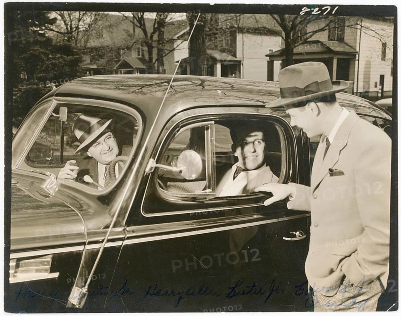 Three men around a car, funny scene, Michigan, USA, Three men in suits and hats, two in the car talking on the street, around 1960