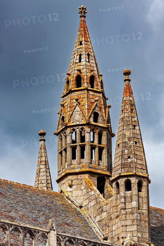 Pointed Gothic stone church tower against a cloudy sky, Saint-Paul-Aurélien Cathedral in Saint-Pol-de-Léon, Brittany