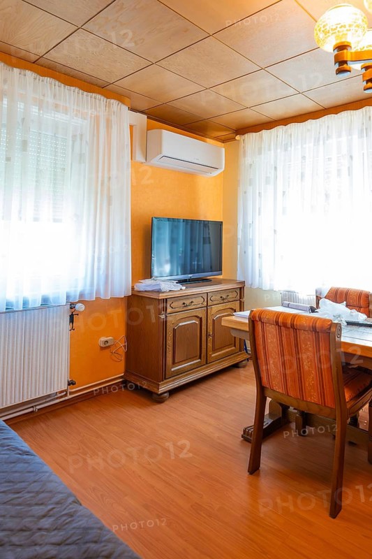 Cosy living room with air conditioning, television and orange walls, air-conditioning and refrigeration technology, private house, Wurmberg, Germany