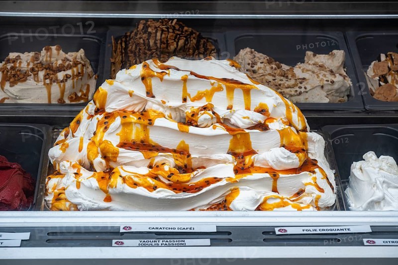 Accumulated ice cream coated with caramel sauce in an ice cream display case at an ice cream parlour in the old town of Saint Malo, followed by other types of ice cream, ice cream specialties, Ille-et-Vilaine department, Brittany, France