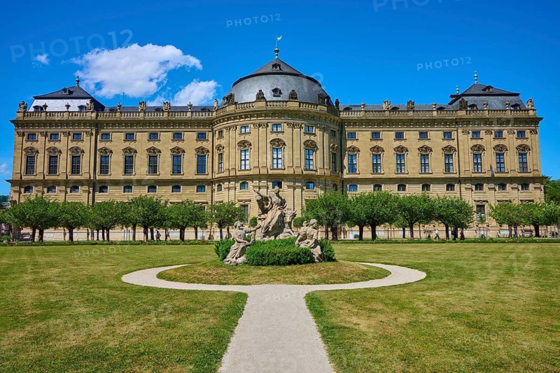 A baroque castle with an extensive garden and lawn, decorated with sculptures, Hofgarten, Residenz, Würzburg, Mainfranken, Bavaria, Germany