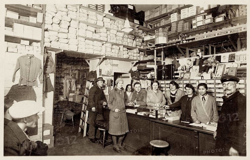 Shop counter, warehouse, clothing, accessories, laundry shop, shop, profession, twenties, saleswoman, interior view of a full department store with employees behind the counter and many shelves, around 1924