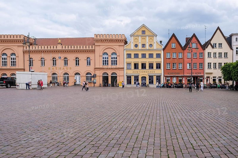 Historic square with colorful buildings and cobblestones surrounded by clouds, Schwerin Old Town, Schwerin, Mecklenburg-Western Pomerania, Germany