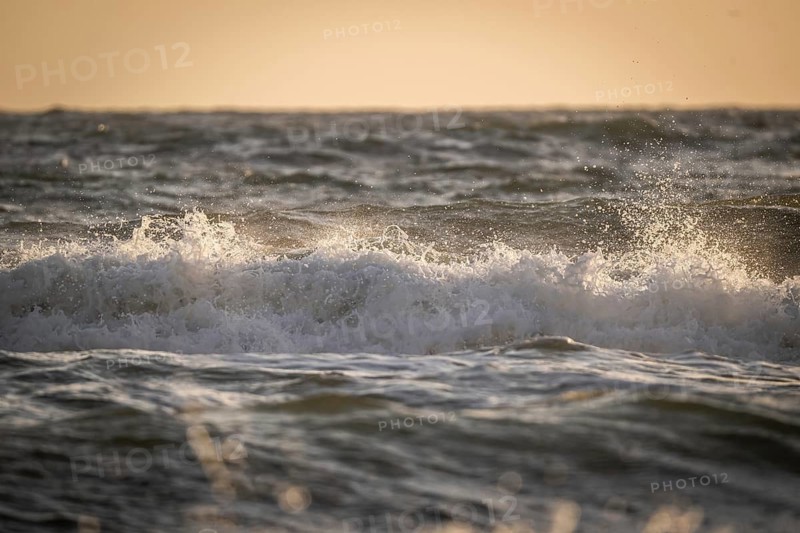 Surf, breaking wave against light, Sortebærdalen Strand, Houvig, North Sea, Denmark