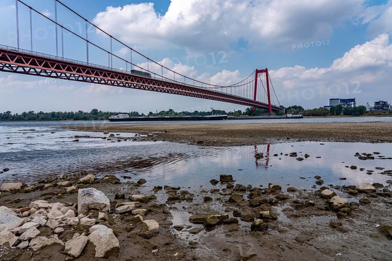 Rhine near Emmerich, extreme low water, Rhine level at 5 cm, downward trend, Emmerich Rhine bridge, cargo ships must travel with sometimes only 30 percent of the usual load, North Rhine-Westphalia, Germany