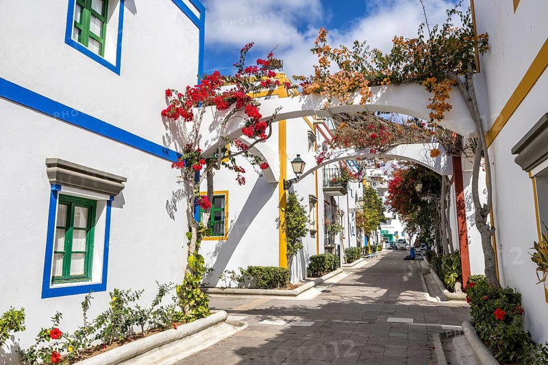 Puerto de Mogan typical colorful houses with flowers on Gran Canaria island vacation trip in Puerto de Mogán, Spain