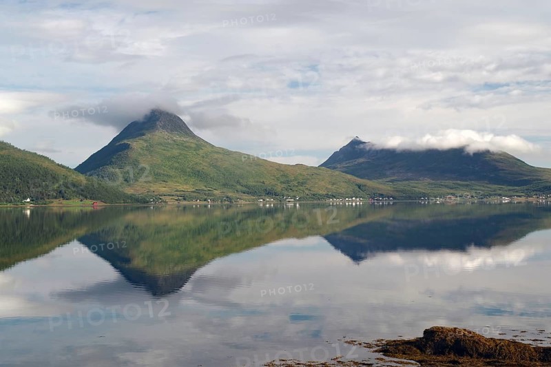 Mountainous landscape with a lake that clearly reflects the surrounding area and clouds under a mostly cloudy sky, Fjordbotn Camping, Botnhamm, Troms, Senja, Norway