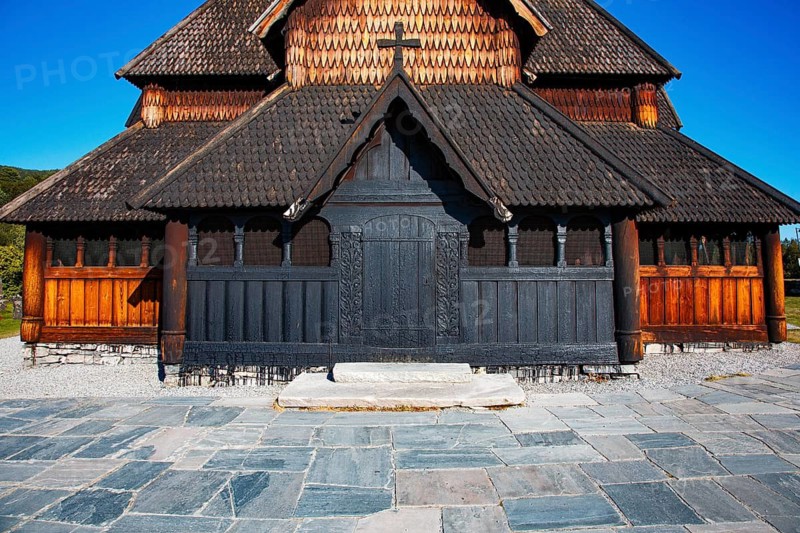Detailed view of the wooden façade of a church with shingle roof under a clear sky, Heddal Stave Church, Notodden, Norway