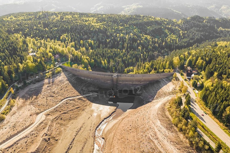Aerial view of a dam surrounded by dry, wooded landscape, emptied Schwarzenbach dam, Forbach, Black Forest, Germany