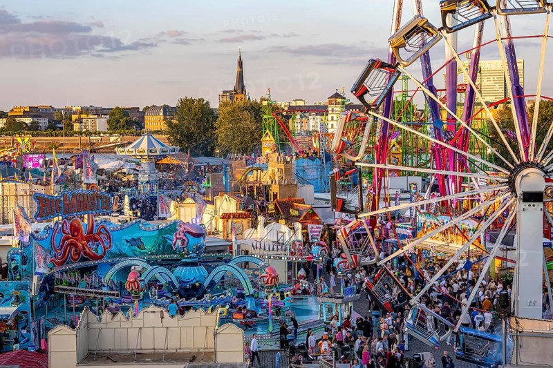 Rhine fair in the Rheinwiesen in Düsseldorf-Oberkassel, view towards the banks of the old town, rides, fairground stands, full aisles, lots of visitors, North Rhine-Westphalia, Germany