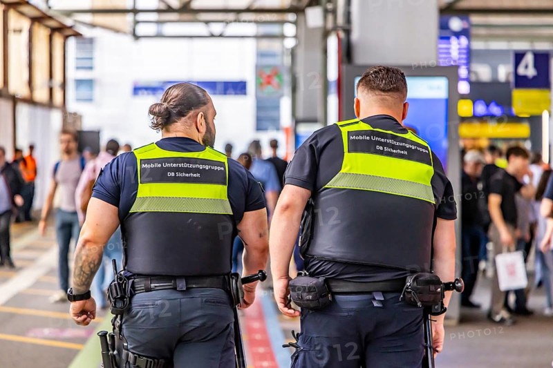 Security personnel at Stuttgart Central Station. DB Security Mobile Support Group. Travelers in the train station. Stuttgart, Baden-Württemberg, Germany