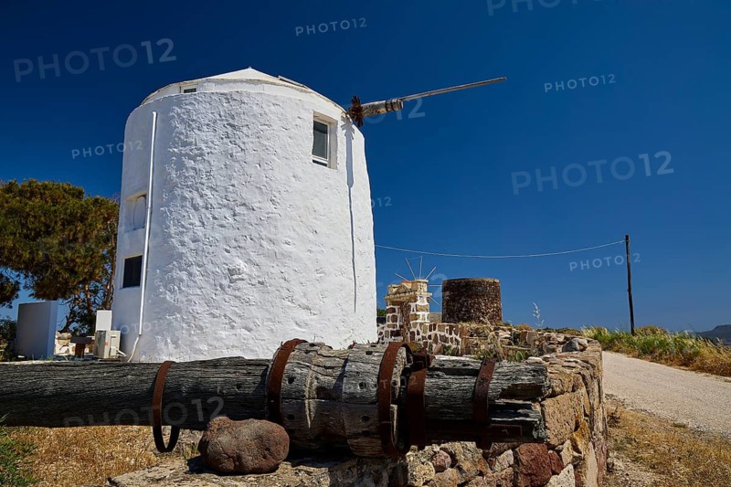 White windmill with stone wall in a quiet rural area, Trypiti, Tripiti, village, Milos, island, Cyclades, Greek Islands, Greece