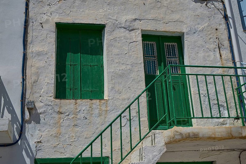 Old building with green door and shutters, rustic façade, Plaka, main town on Milos, Milos island, volcanic island, Cyclades, Greek Islands, Greece