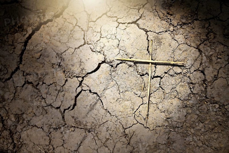 Dry soil with cracks and crosses, symbolic photo of damage caused by climate change, drought and drought, photo montage +++ editorial use only