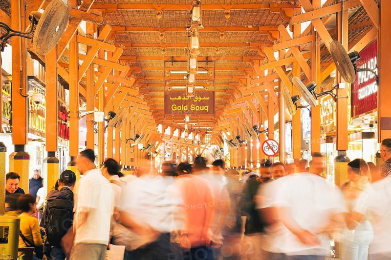 Dubai, UAE - 17th january, 2026: Dubai Gold Souk in Deira. Zoom in timelapse crowds visitors under traditional wooden architecture historic bazaar. Gold industry trade investment background concept