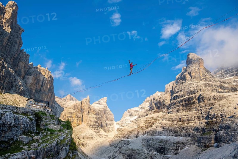 Slackliner in the mountains, mountain peaks of the Brenta Mountains, at Refugio Francis Fox Tuckett, Brenta, Brenta-Adamello Natural Park, Trentino, Italy
