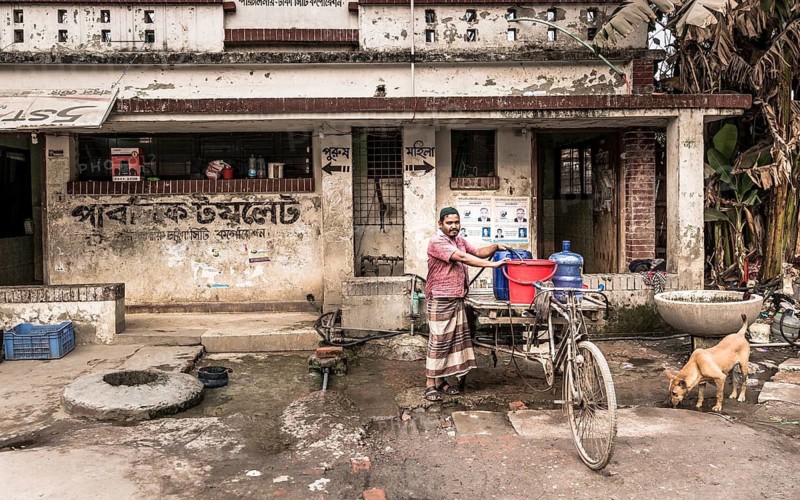 Man with rickshaw fetching water, Dhaka, Bangladesh