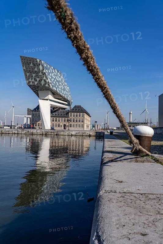 The Antwerp Port Authority building, Havenhuis, former fire brigade barracks in the harbour, renovated and with an attached glass structure in the shape of a ship's hull, administrative headquarters of the Antwerp Port Authority, designed by Zaha Hadid, Antwerp, Flanders, Belgium