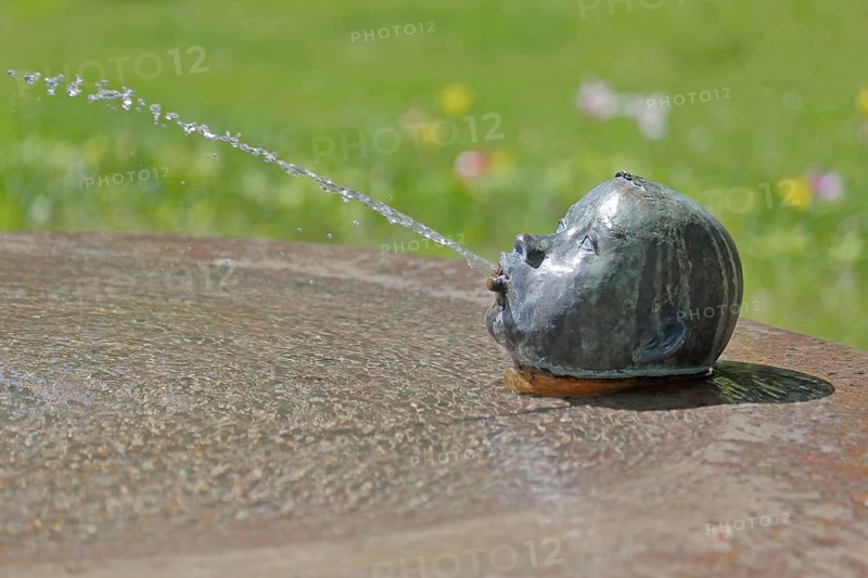 Fountain with sculpture by Günter Kaden 2001, water spitter, spit, water jet, head, child, stone, looking out, market, Rheinsberg, Ruppiner Switzerland, Ruppiner Land, Brandenburg, Germany