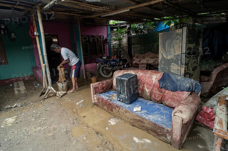 Resident cleaning inside his mud-filled and flood-damaged home after floodwaters receded on July 26, 2026 in Sivasagar, India. The flood situation in Assam has improved following the recession of floodwaters. However, more than 700, 000 people across 21 districts have been affected by the floods, while the state's death toll has risen to 60