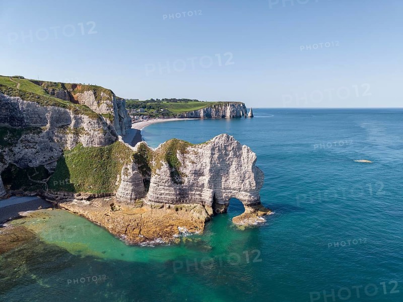 Aerial view of the Falaise d'Amont rock formation with the Porte d'Amont rock gate at low tide, on the horizon the Porte d'Aval rock formation, Étretat, Alabaster Coast, La Côte d'Albâtre, chalk cliffs, English Channel, Seine-Maritime, Normandy, France
