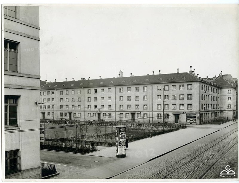 Multi-storey residential buildings along a street, early 20th century, quiet city atmosphere