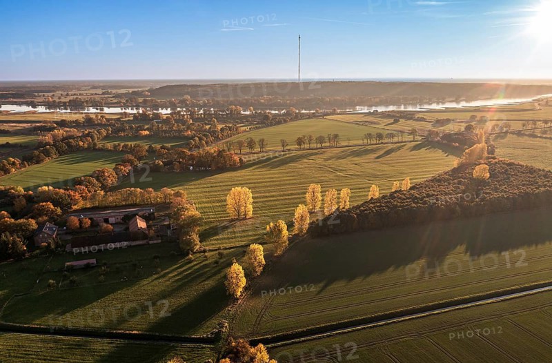 Aerial view of farmland and river Elbe near Lenzen, view to Höhbeck radio mast, sunset, Germany