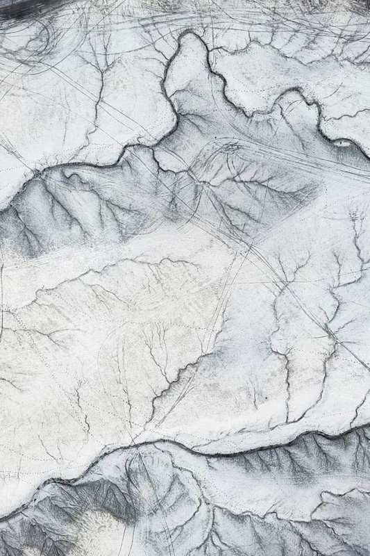 Intricate aerial view of Moonscape Overlook in Utah, showcasing the distinct and rugged terrain with a texture that mimics an otherworldly landscape
